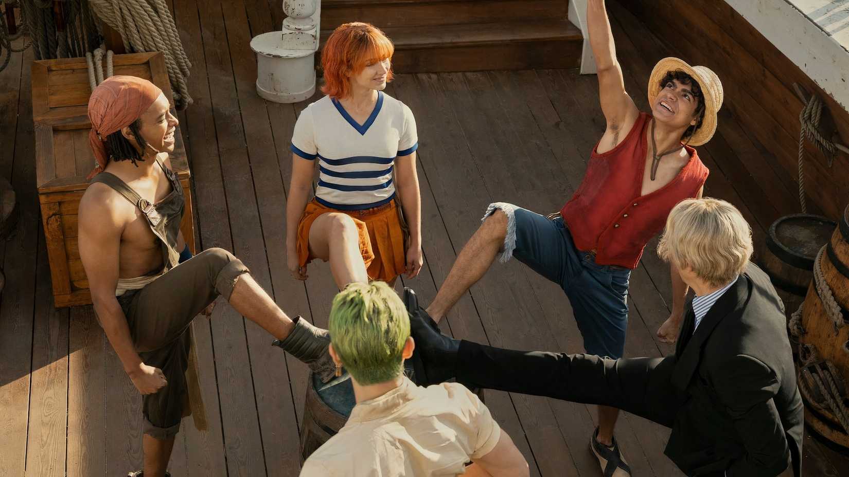 Monkey D. Luffy, Sanji, Nami, Usopp, and Roronoa Zoro put their feet on a barrel in Netflix's One Piece