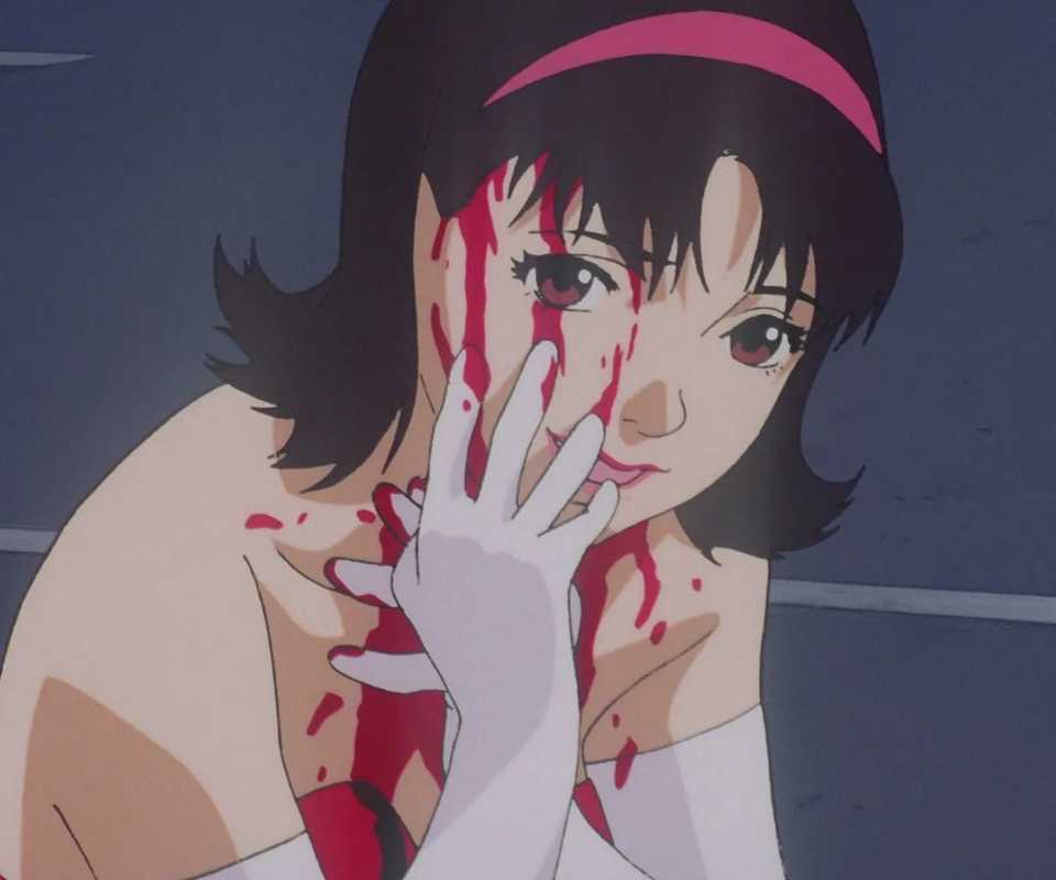 Pop idol Mima Kirigoe wipes blood on her face in Perfect Blue.
