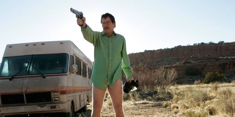 Walter White in the desert standing by the RV in a green shirt and underwear holding a gun from Breaking Bad.
