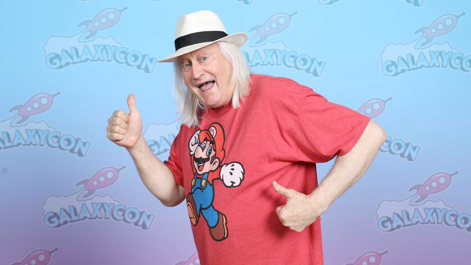 Charles Martinet wearing a Mario shirt and posing at GalaxyCon Austin 2023