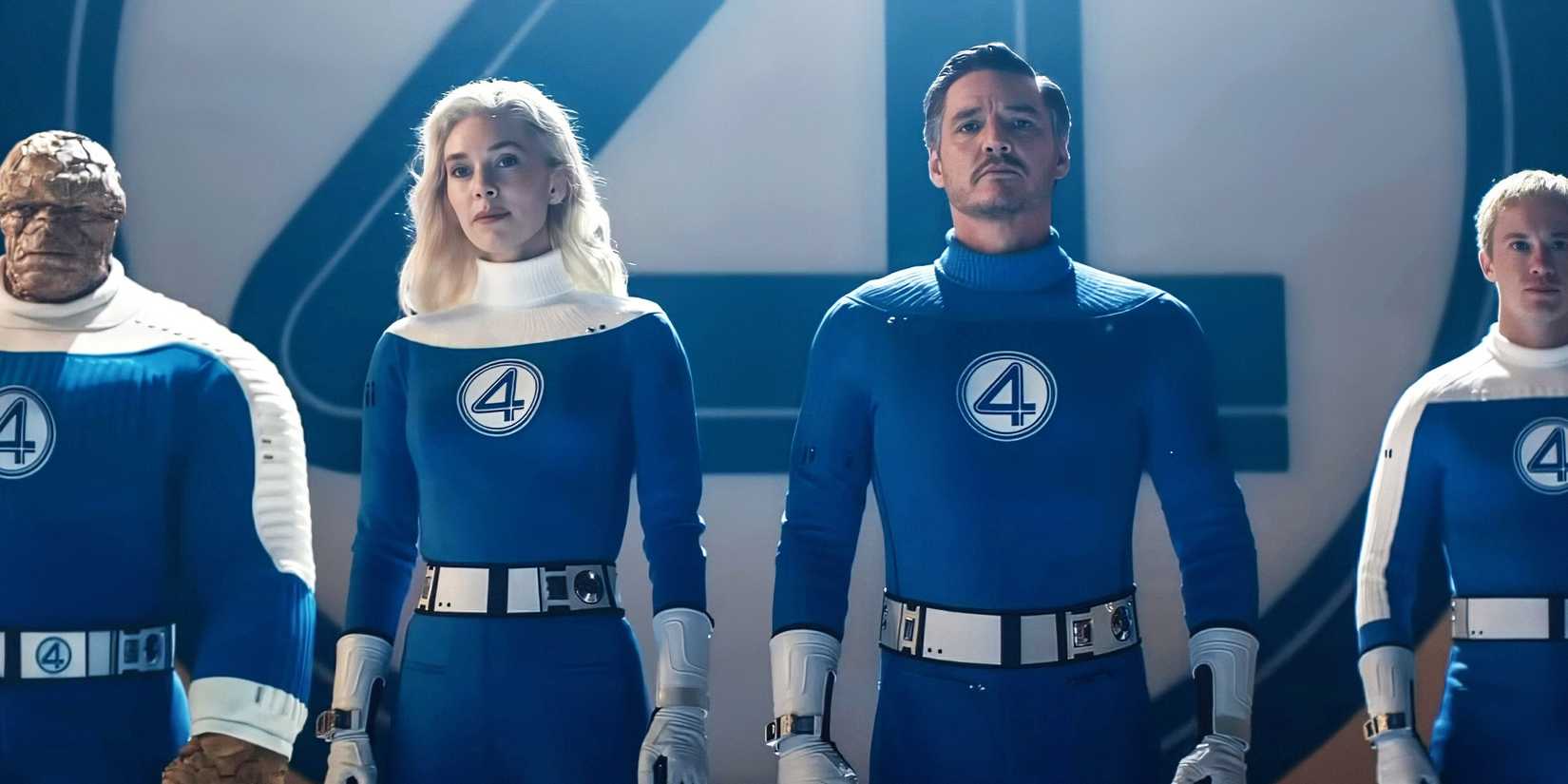 The fantastic four standing together in front of logo