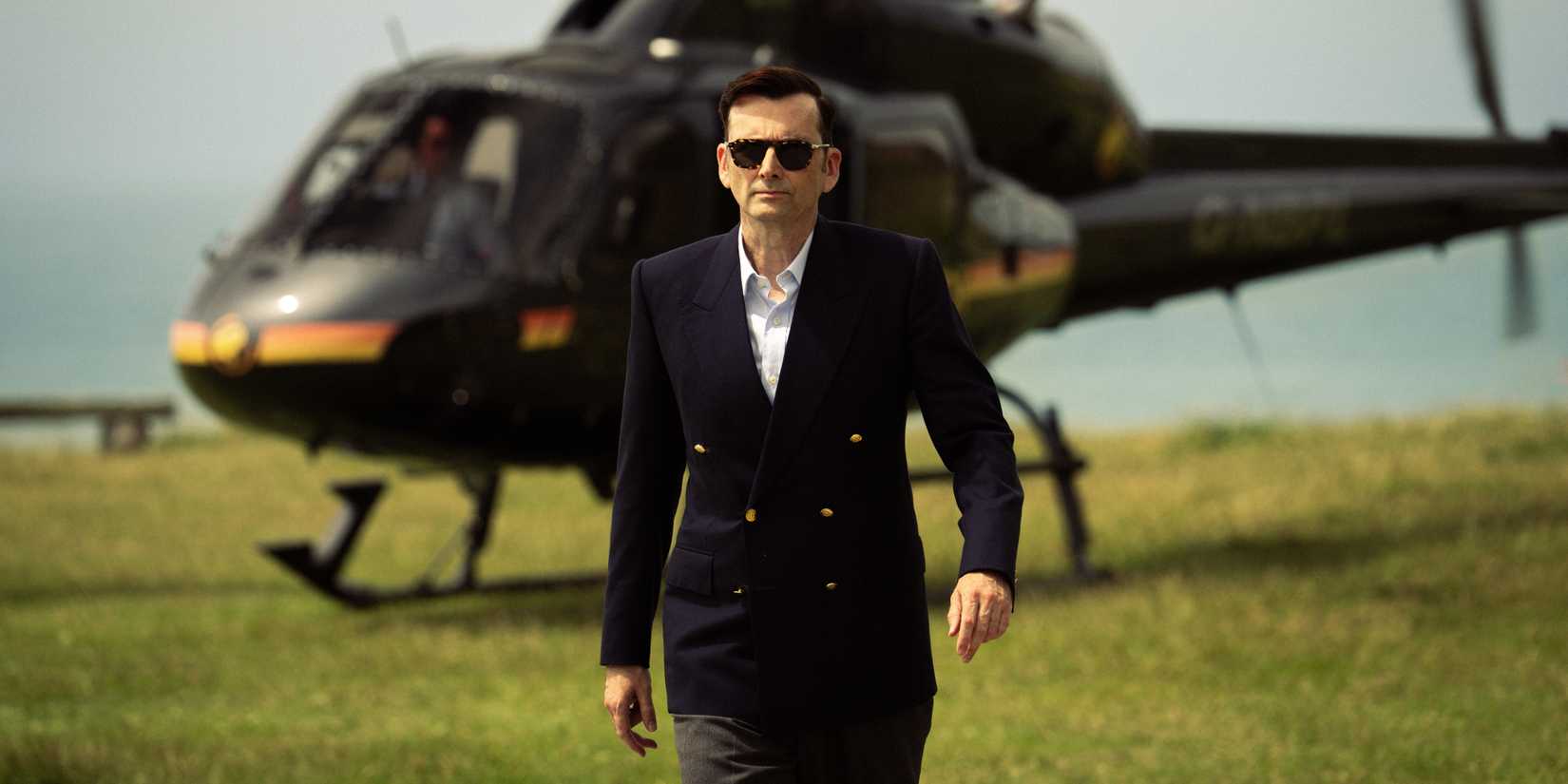 David Tennant walks in front of a helicopter in Rivals Season 2.