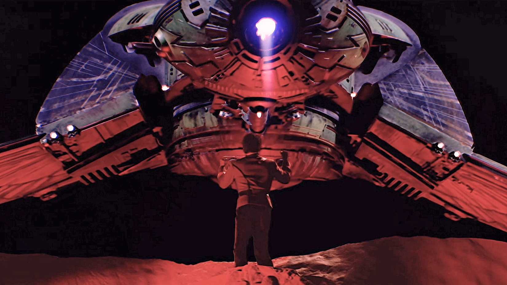 Captain Kirk in a red uniform standing on a cliff, back to camera, with a Bird of Prey hovering in front of him