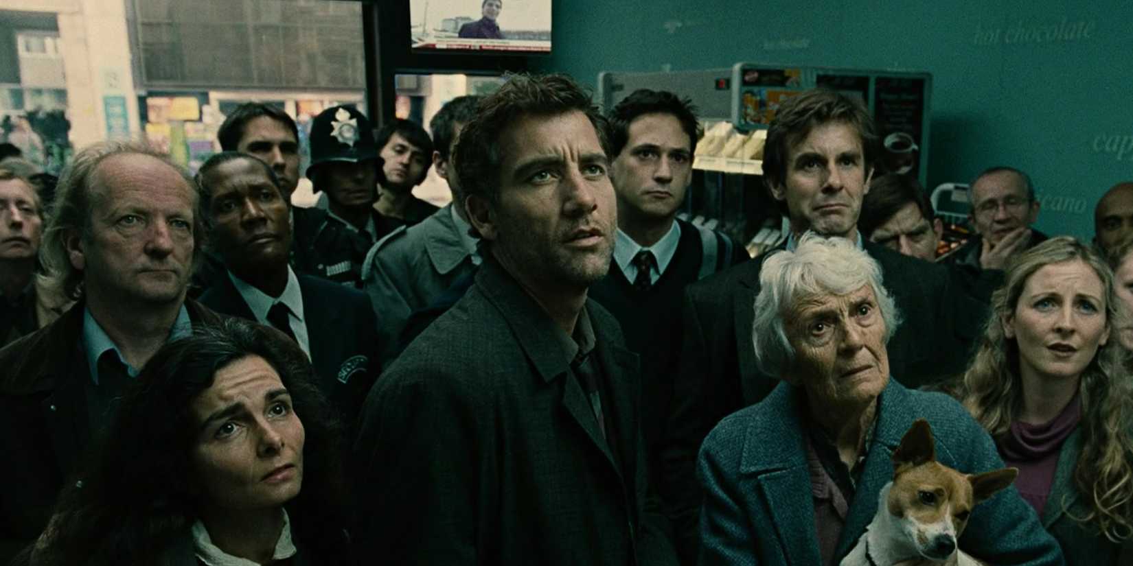Clive Owen with the crowd watching the news in the opening shot of Children of Men