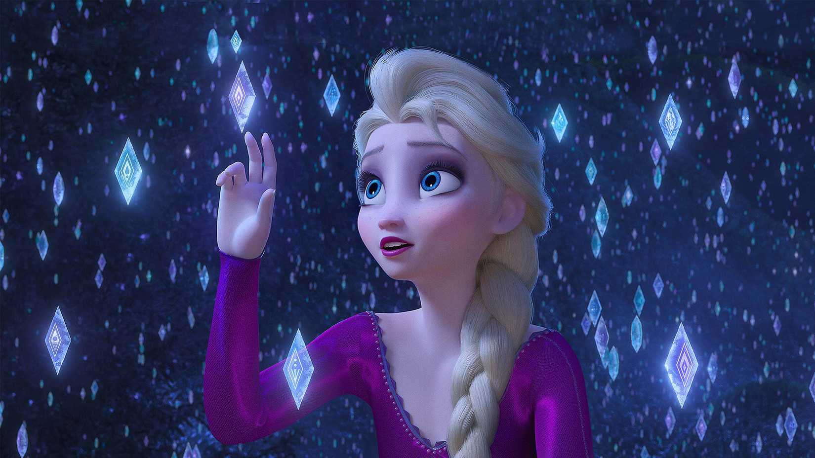 Elsa wears a purple dress and gently touches the floating ice triangles.