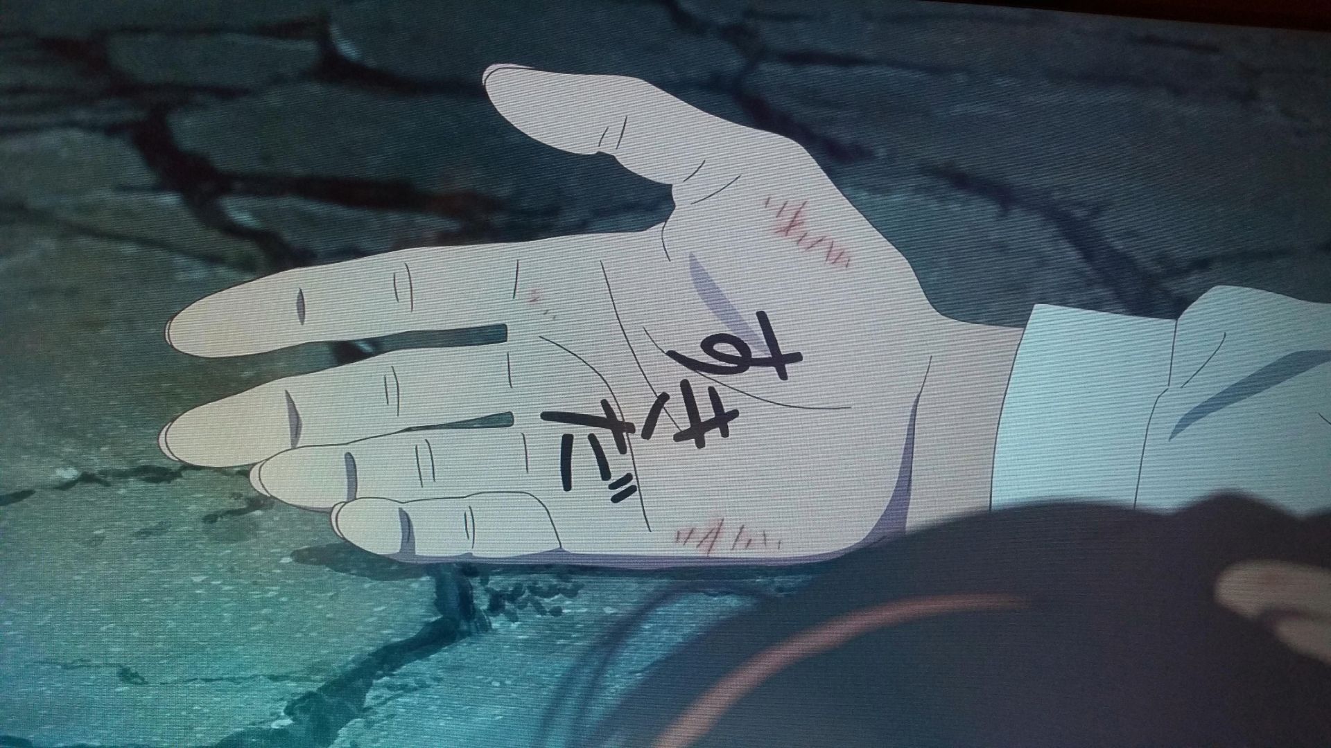 Mitsuha opens her hand to reveal the words "I love you," in Your Name.