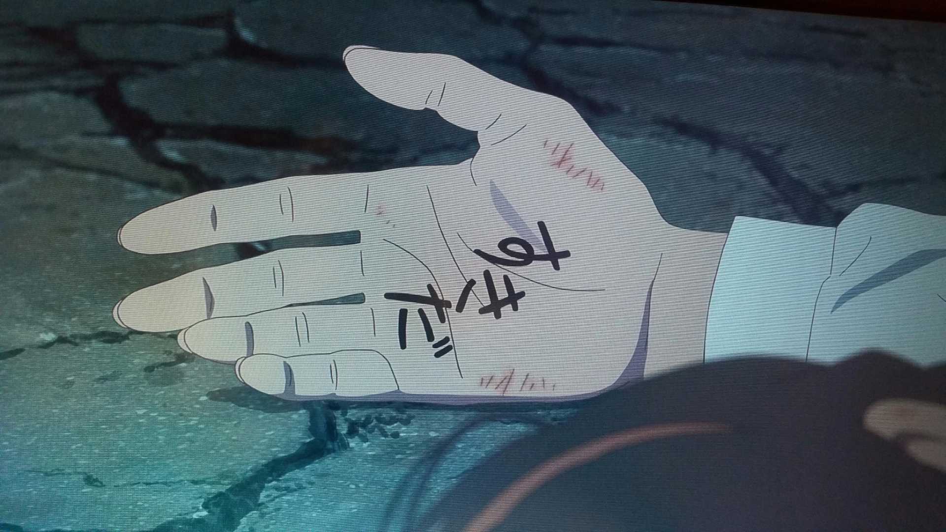 Mitsuha opens her hand to reveal the words "I love you," in Your Name.