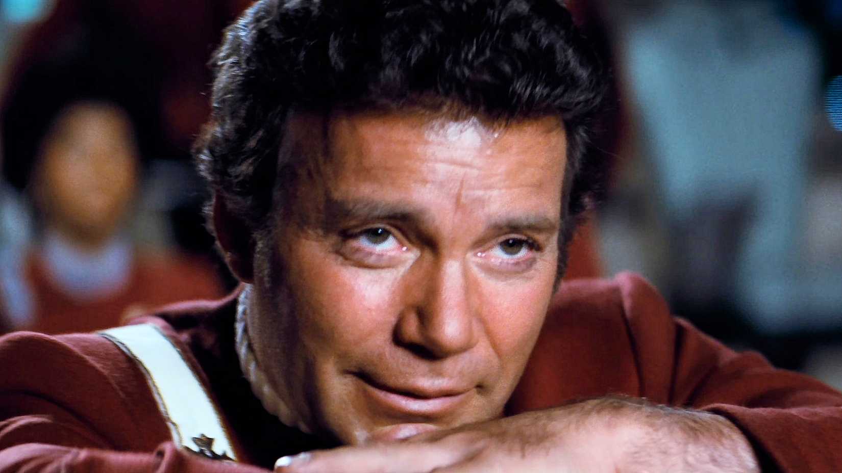 Admiral James Kirk leans his head on his forearms on the bridge in Star Trek II The Wrath of Khan