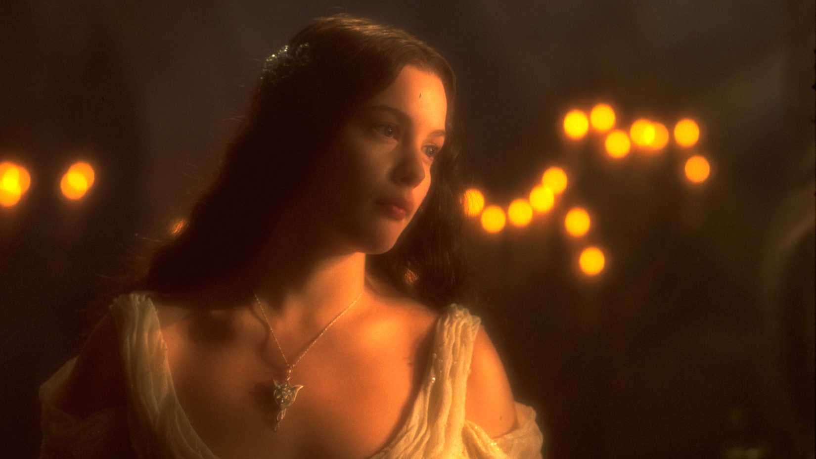 Arwen illuminated by candles in a promotional still for The Lord of the Rings: The Fellowship of the Ring