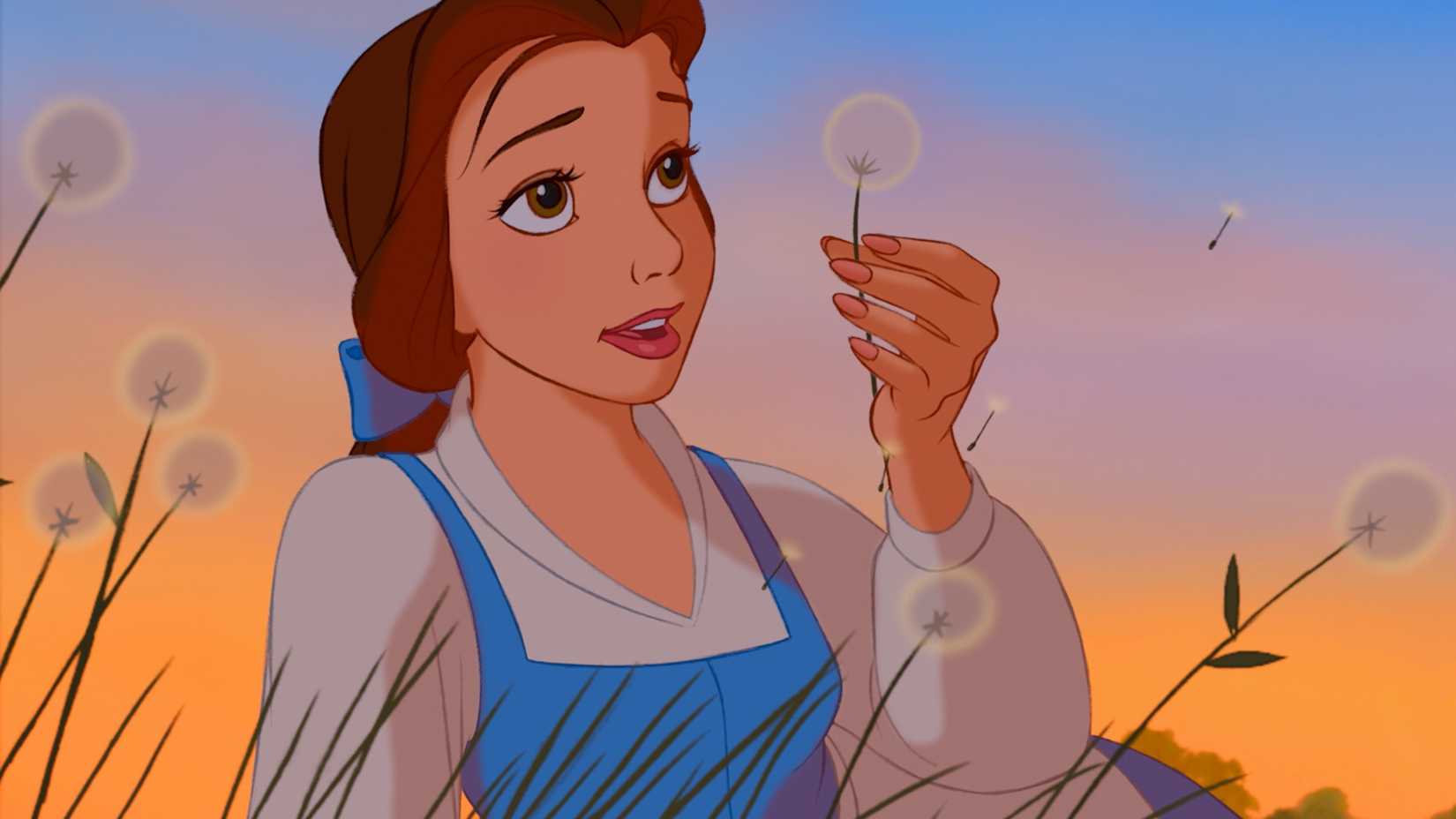 Belle holds up a dandelion in Beauty and the Beast.
