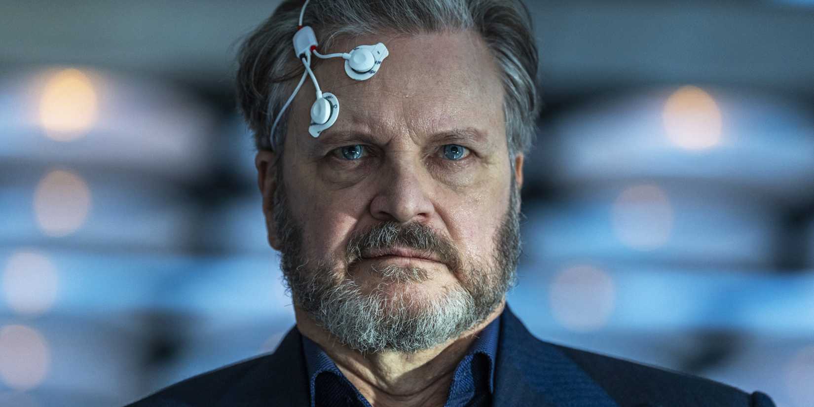 Colin Firth with nodes on his head in Disclosure Day