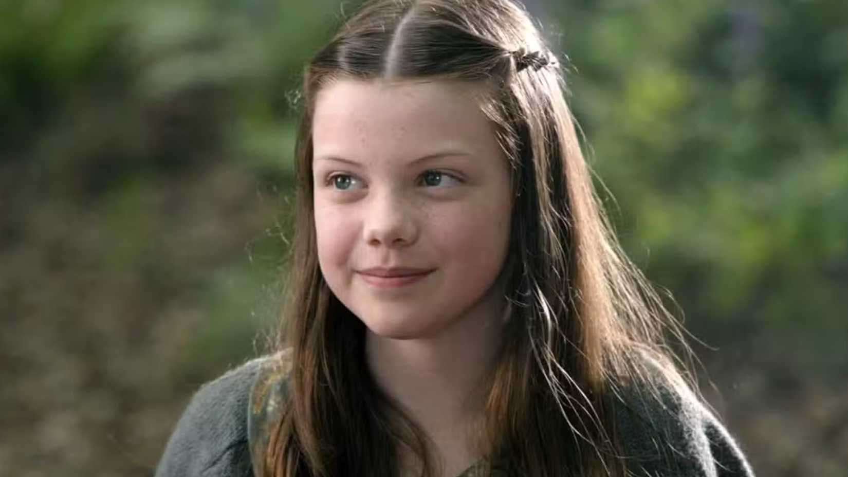 Lucy Pevensie smiles in Narnia.