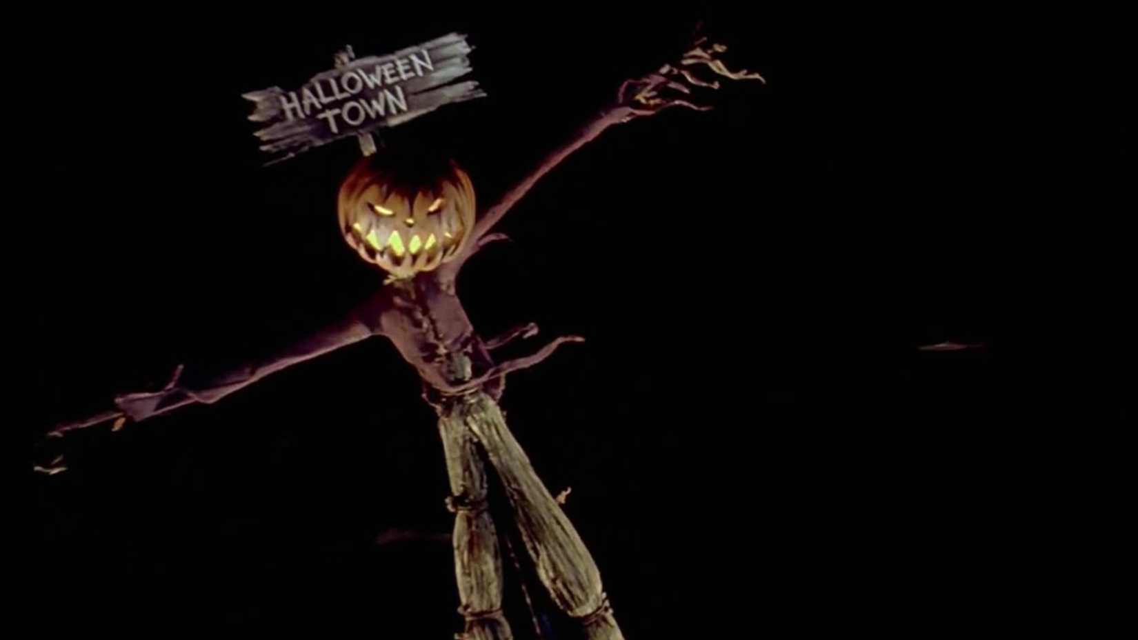 A scarecrow with a pumpkin head that reads "Halloween Town" hangs crookedly in The Nightmare Before Christmas.