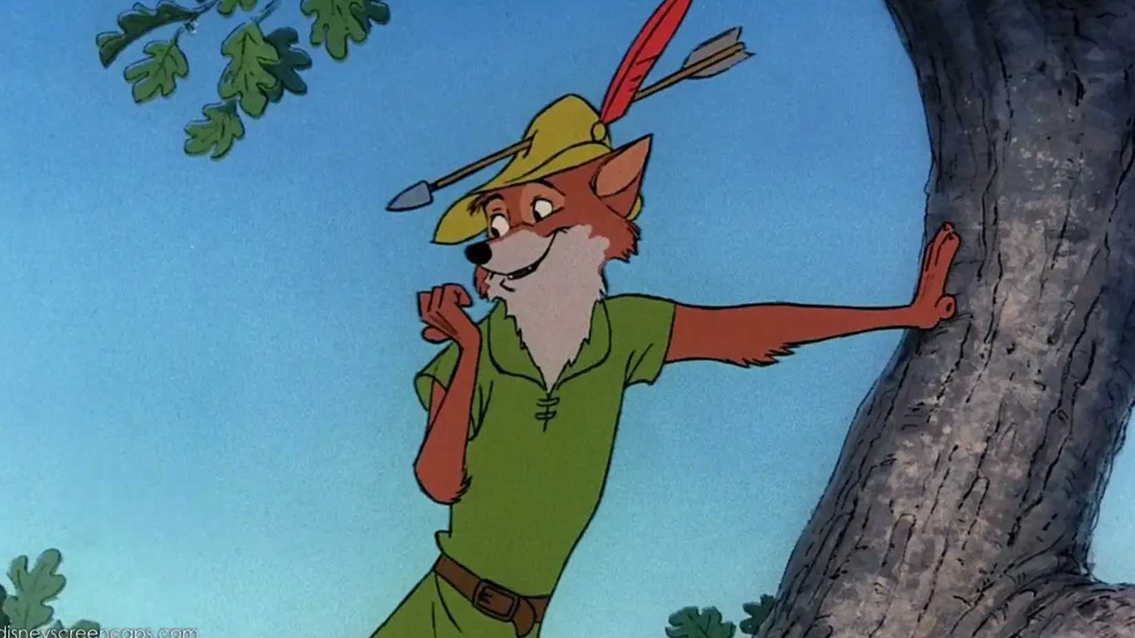 Robin Hood stands on a tree with an arrow through his hat.