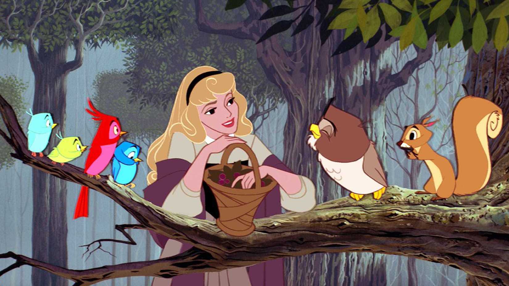 Aurora holds a basket of berries while her woodland friends look at her in Sleeping Beauty.