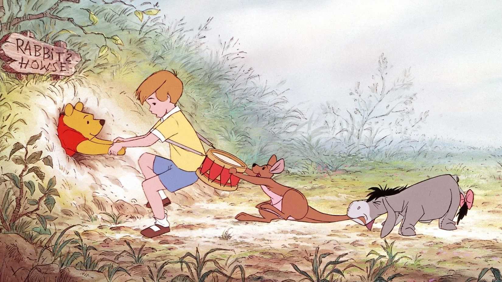 Pooh is stuck in a hole while Christopher Robin, Kanga, and Eeyore try to pull him out.