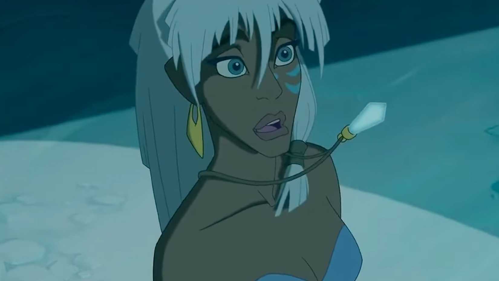 Kida looks delighted as her crystal is held up in Atlantis: The Lost Empire.