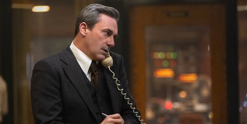 Fred in his office on the phone taking notes on a pad in American Hostage.