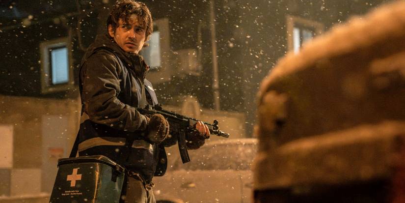 Bryan (Austin Abrams) walks down the street in Raccoon City carrying a gun in Resident Evil 2026