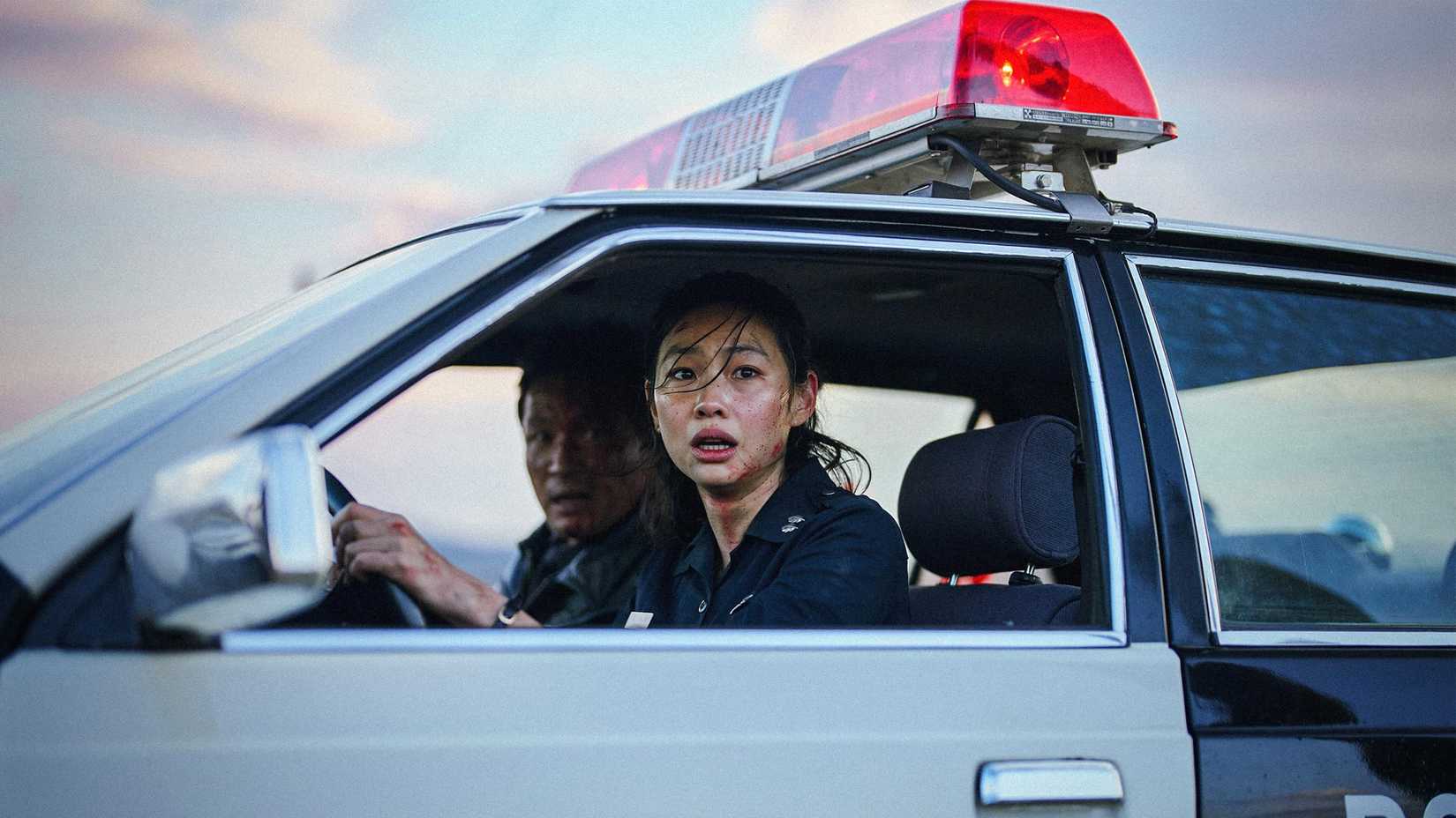 Jung Ho-yeon as Sung-ae looking shocked in a police car in Hope