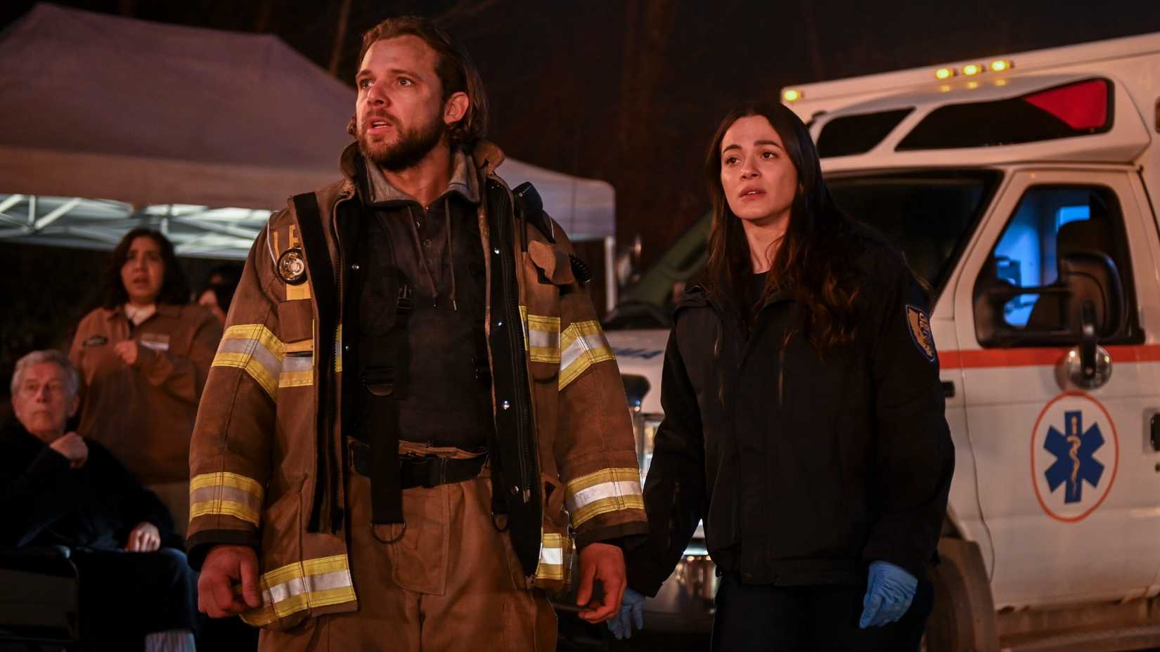 Max Thieriot as Bode Leone and Stephanie Arcila as Gabriela Perez looking worried during a call on Fire Country.
