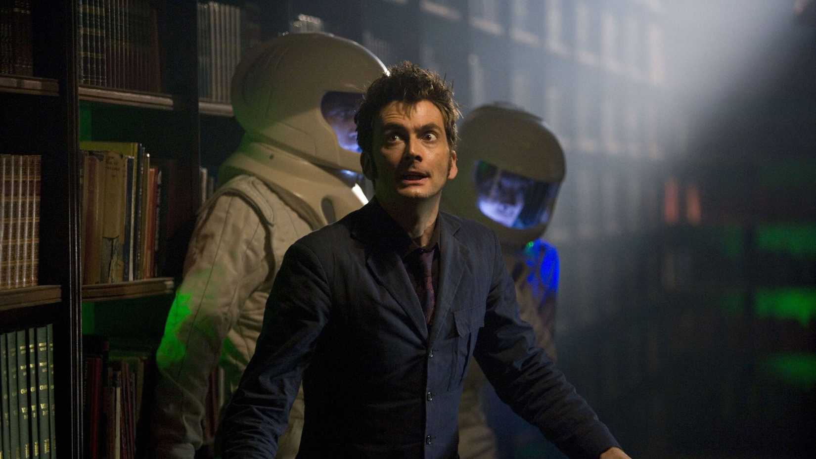 David Tennant as The Doctor with scientists in hazmat suits behind him from Doctor Who's Silence in the Library