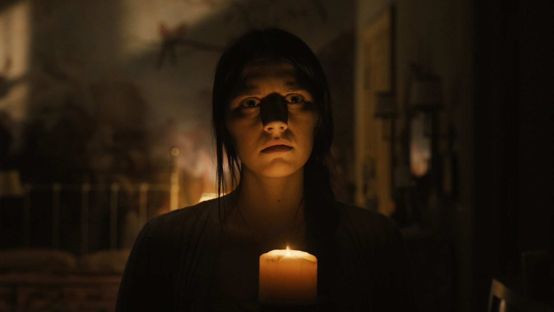 Nell Tiger Free holds a candle as Leanne in Servant